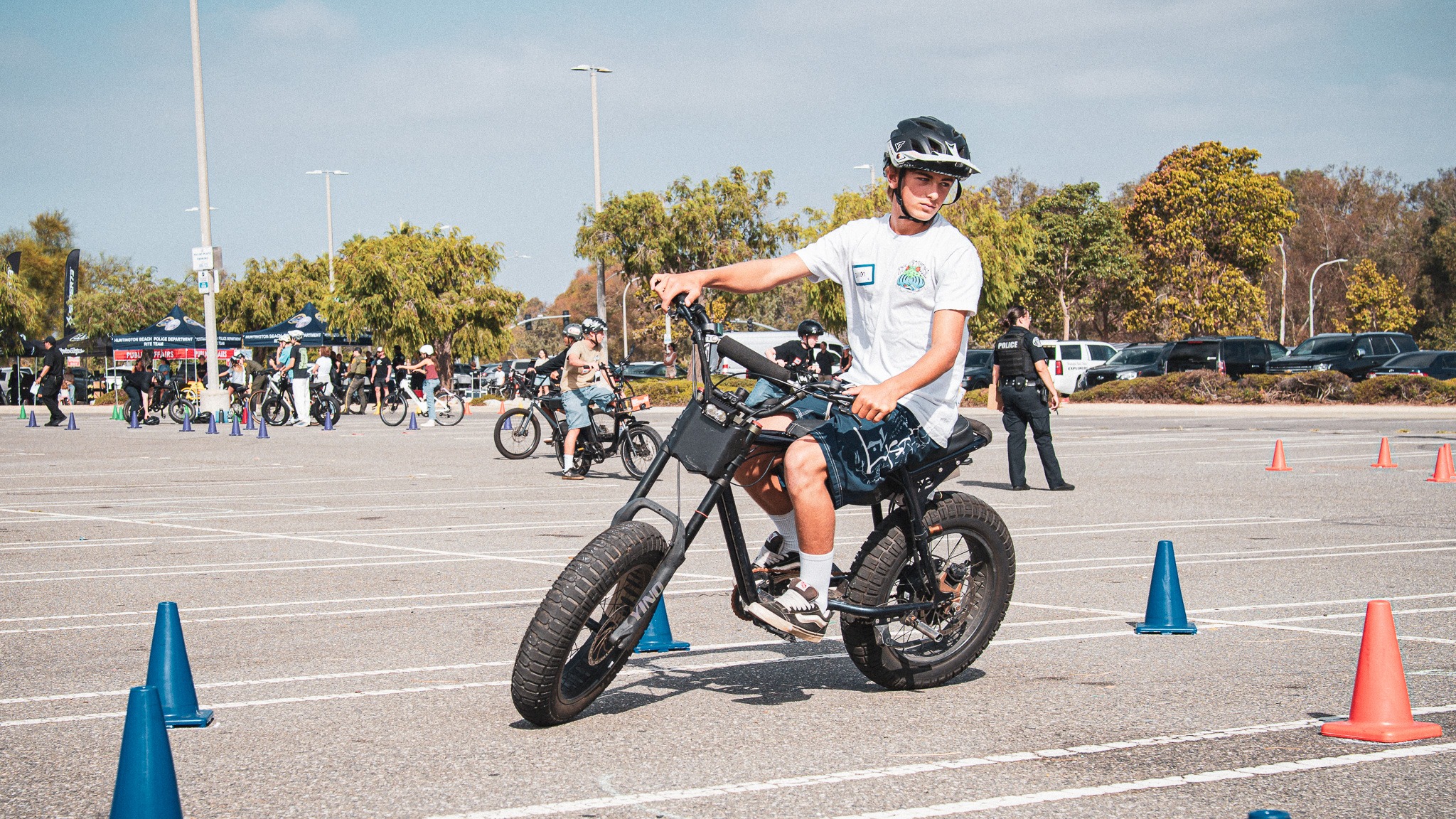 A helmeted young rider practicing a controlled turn through training cones
